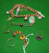 A Victorian gold curb link bracelet, stamped 15ct, suspending various charms including a turquoise