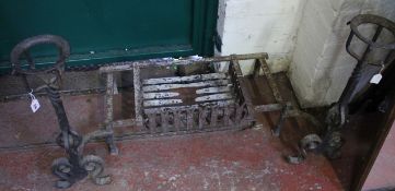A pair of andirons together with a fire basket There is no condition report available on this lot.