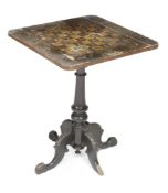 A Victorian ebonised games table 68cm high, 53cm wide