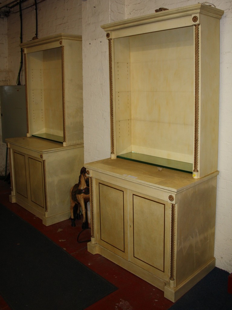 A pair of modern painted bookcases with glazed upper part and cupboard below, 239 x 110cm