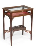 An Edwardian mahogany bijouterie table with blind fret decoration and a lower tier 58cm wide There