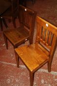 A set of eight Art and Crafts style oak chairs