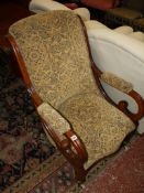 A Victorian mahogany upholstered open armchair