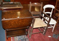 An oak dropside table, a rush seat rocking chair and a white painted chair. A condition report is