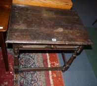 A 17th Century oak side table with a frieze drawer on baluster turned and block legs joined by