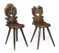 A pair of Continental carved oak and walnut hall chairs, late 18th/early 19th century, each pierced