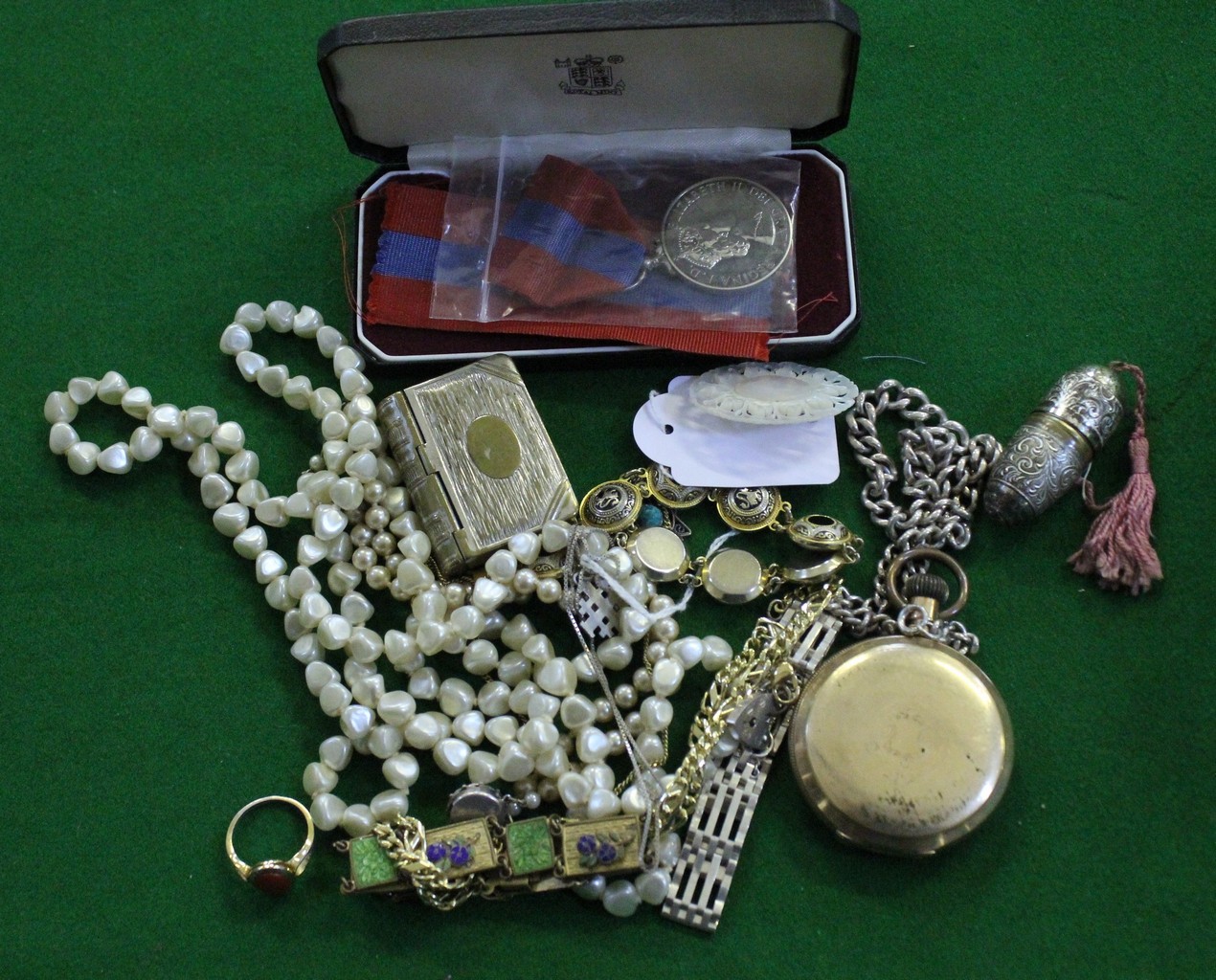 A collection of costume jewellery, including: a silver coloured curb link chain; an enamelled