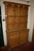 A 19th Century style pine dresser with a platerack, the lower part with drawers and cupboards
