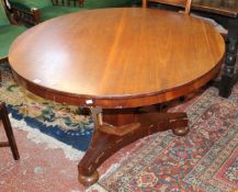 A 19th Century mahogany breakfast table on facetted column and triform base with squat ball feet