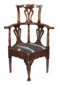 An 18th century and later elm, oak and fruitwood corner chair, circa 1770, of country make, the