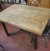 A 20th Century oak draw leaf dining table with X-frame stretcher There is no condition report