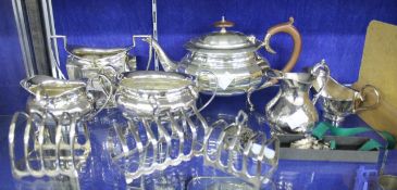 Two silver toast racks, London 1932 and Birmingham 1960; a plated three piece tea service; and
