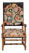 A Continental walnut and oak armchair, 18th Century with later elements with rectangular needlework