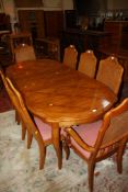 A modern French style oak and crossbanded dining suite comprising extending table 226cm length and