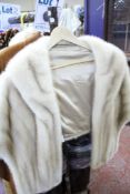 A 1950s pale mink fur stole with an oyster coloured silk lining; together with a 1950s fur coat.