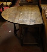 A 17th Century style oak gateleg table with a frieze drawer on ring turned legs 71cm high, 147cm