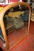 A pine framed arched top overmantel mirror 139cm high, 137cm wide