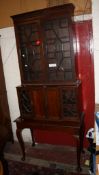 An Edwardian mahogany glazed bookcase with cabinet below 222cm high, 98cm wide A condition report