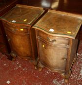 A pair of walnut serpentine fronted bedside cabinets on short cabriole legs 38cm wide