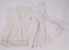 An 1840s christening gown; together with a 1930s white lawn dress for a child; and another