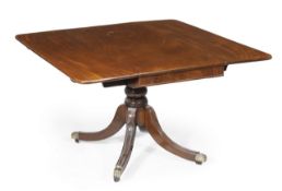 A George IV mahogany pedestal dining table, circa 1825, two hinged rectangular leaves, turned stem,