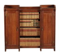 A Victorian oak bookcase, circa 1880, in the manner of Shoolbred & Co., bearing a partial label for