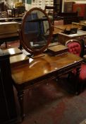 A Victorian mahogany dressing table with mirror flanked by two drawers and two further frieze