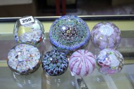 Seven assorted paperweights, including Venetian examples