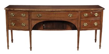 A George III mahogany bowfront sideboard, circa 1800, the central frieze drawer and recessed