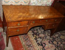 A Sheraton satinwood and crossbanded sideboard with five frieze drawers on square tapering legs and