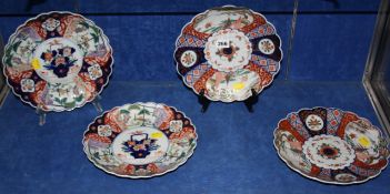 A set of four 19th century scalloped Imari plates