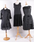A Galliano 1980s low waisted black cotton dress trimmed with black lace, having 03-Apr length