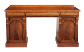 A William IV mahogany sideboard circa 1835 with a rectangular top, three cushion moulded drawers