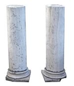 A pair of striated grey stone columnar pedestals, late 19th century, on waisted socles and square