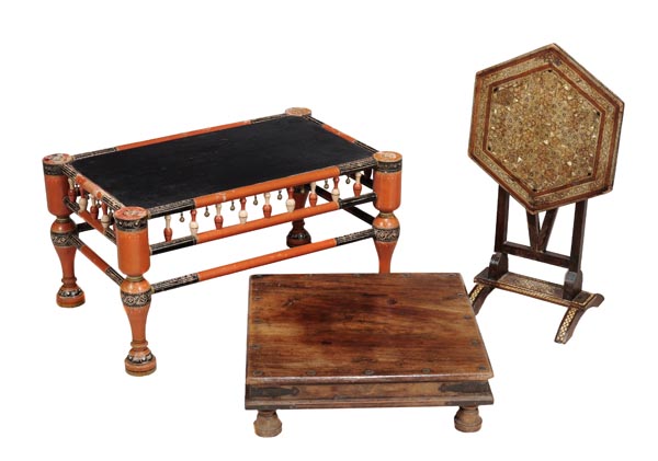 An Indian ebonised and orange painted occasional table, 20th century, the rectangular top above a