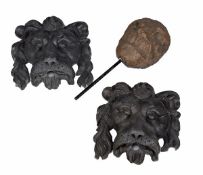 A pair of lead coloured lion mask wall plaques, 20th century, formed of fibre glass, 47cm high,