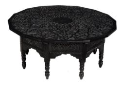 A Moroccan ebonised wood low table, late 19th/early 20th century, the top with central cartouche