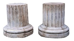 A pair of substantial stoneware columnar pedestals, early 20th century, with fluted sides and