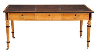 A Victorian oak and ebonised writing table, circa 1880, the tooled leather writing surface within