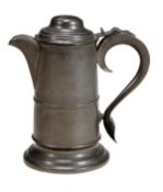 A late George III lidded pewter pitcher, early 19th century, the tapering cylindrical body with