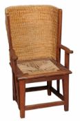 An oak child`s Orkney chair late 19th century with lipwork shaped back and a rush seat with