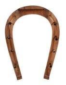 A stained wood coat rack, 20th century, in the form of horseshoe with lacquered brass nail pattern h