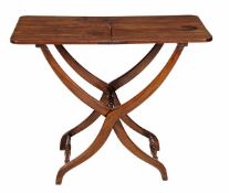 A George IV mahogany coaching table circa 1825, with a rectangular folding top on shaped X-frame