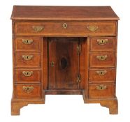 A George III kneehole desk, circa 1770, with one long drawer above two sets of four drawers