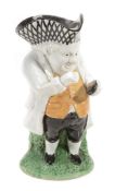 An English pearlware `Snuff-Taker` Toby jug, circa 1830 An English pearlware `Snuff-Taker` Toby jug,