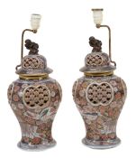 A pair of Japanese Imari vases decorated with typical gilded palette of... A pair of Japanese