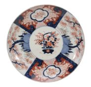 An Imari charger of typical dished, circular form decorated in underglaze blue An Imari charger of