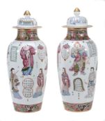 A pair of Chinese porcelain vases and covers decorated in famille rose... A pair of Chinese