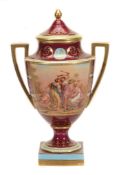 A Vienna-style claret-ground two-handled pedestal urn and cover A Vienna-style claret-ground two-