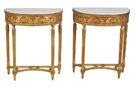 A pair of carved giltwood and marble mounted console tables in George III...  A pair of carved
